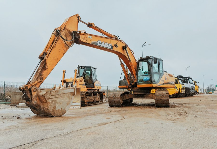 Excavator, dozer and haul trucks staged on a job site