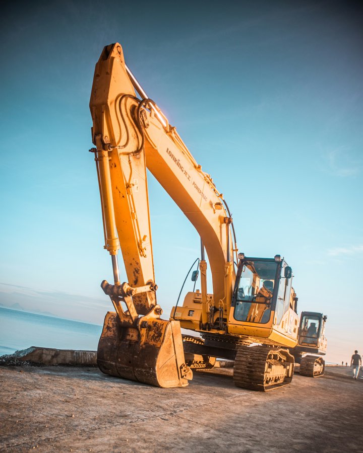 Tracked excavator on a prepared site at golden hour